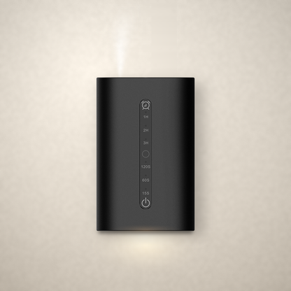 Phynix Fire Studios Waterless Diffuser MINI in black aluminum alloy, front view, plugged into a wall outlet